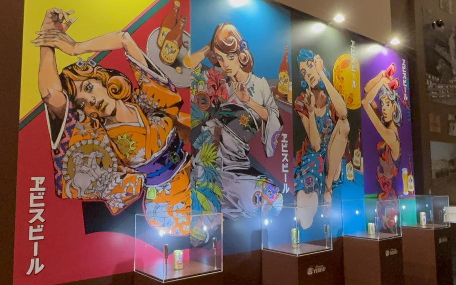 JoJo’s Bizarre Adventure illustrations on the wall and Jojo’s-themed cans on display.